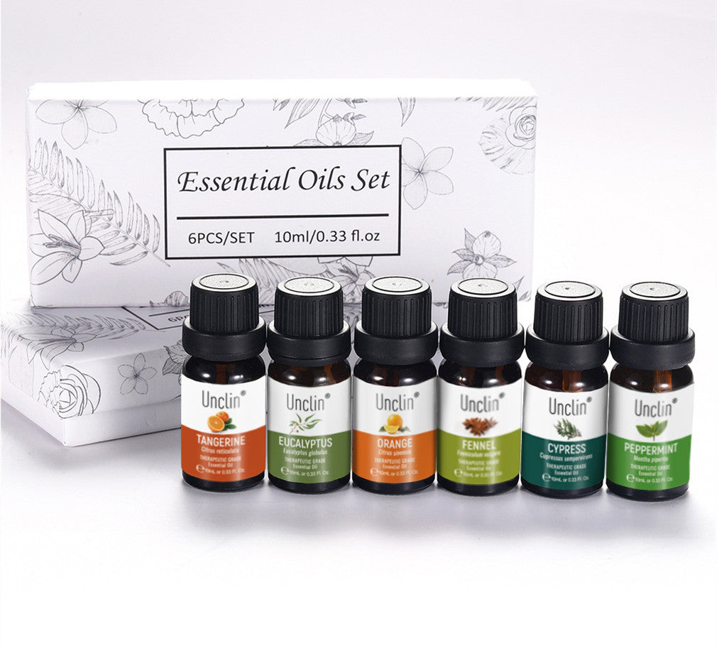Set of six essential oil bottles with a branded box on a white background