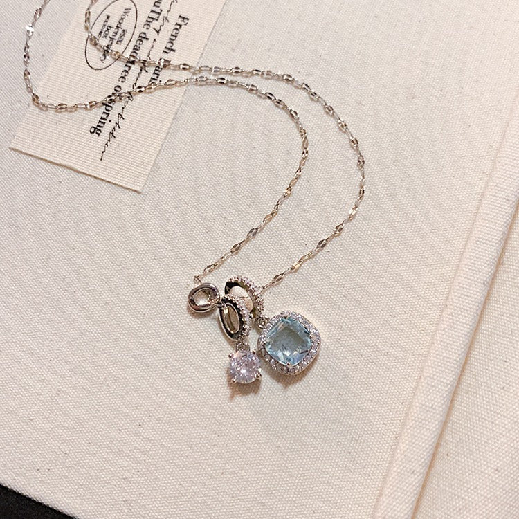 Necklace with pendant on a beige fabric background