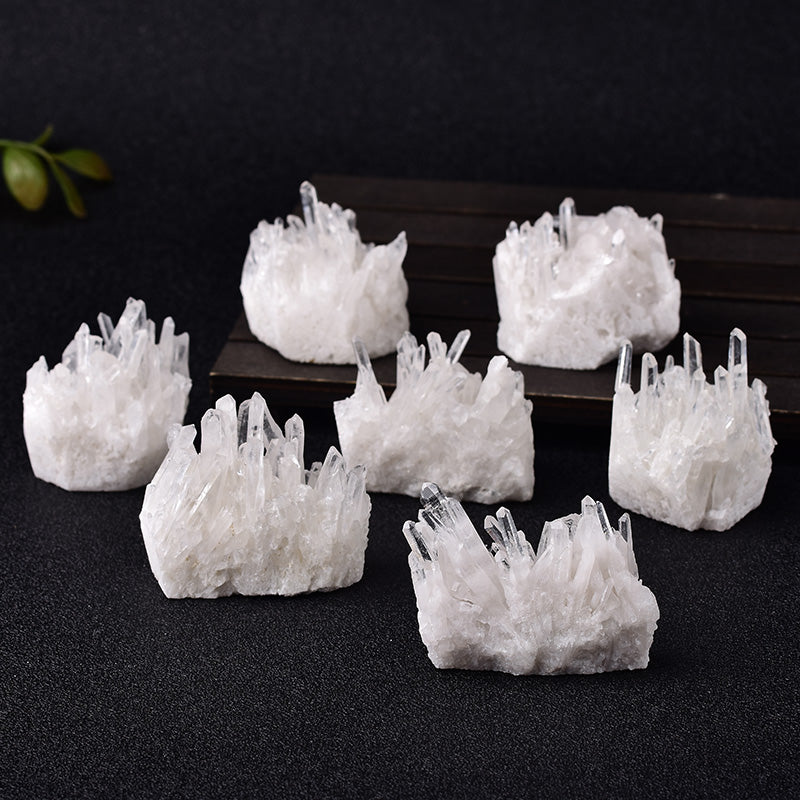 Set of white crystal formations on a dark surface