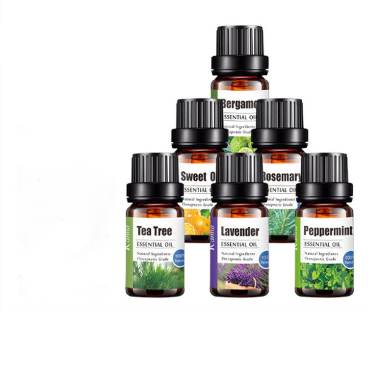 Collection of essential oil bottles with labels on a white background