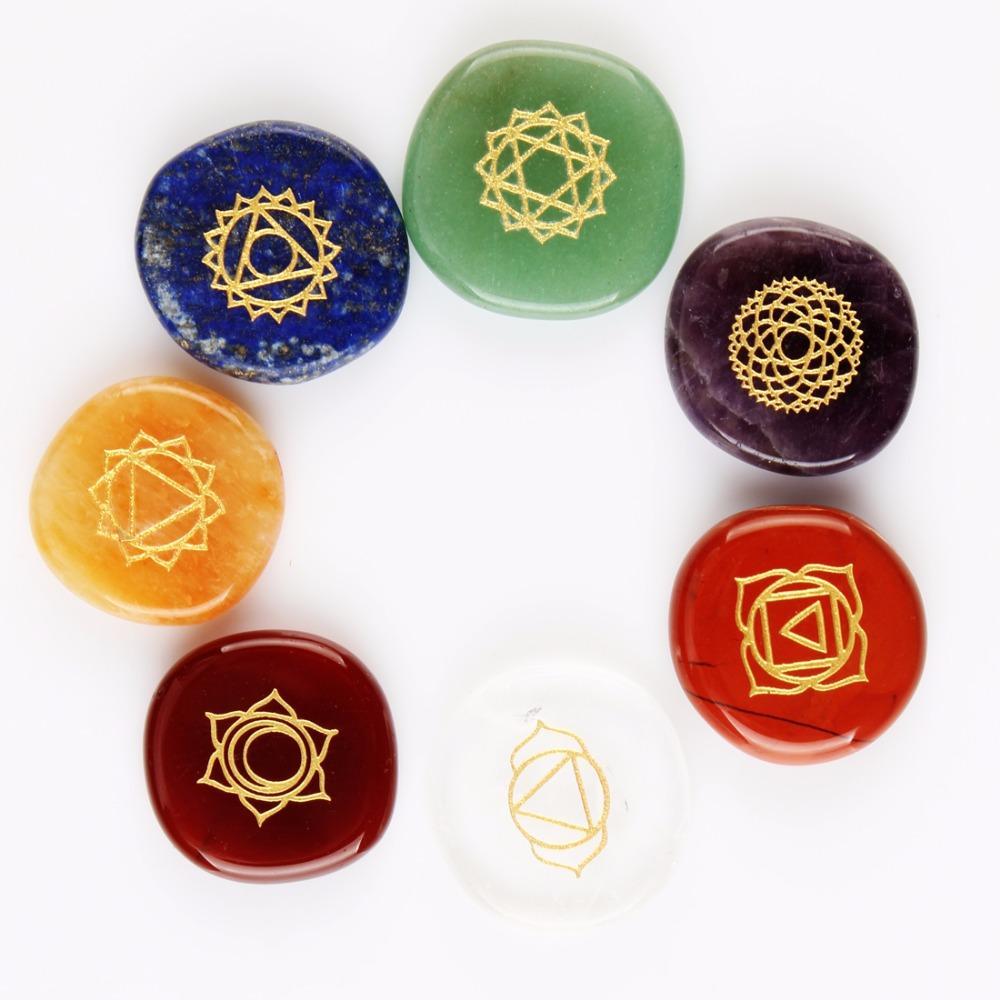 Set of colorful stones with gold symbols on a white background