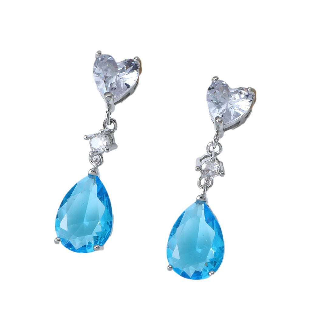 Pair of earrings with heart-shaped and teardrop-shaped gemstones on a white background