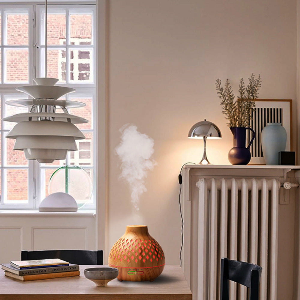 Modern interior with a diffuser on a table, radiator, and decorative items.