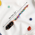 Crystal wand with colored beads and black crystal tip on a white background
