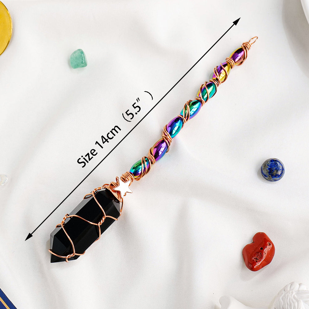 Crystal wand with colored beads and black crystal tip on a white background