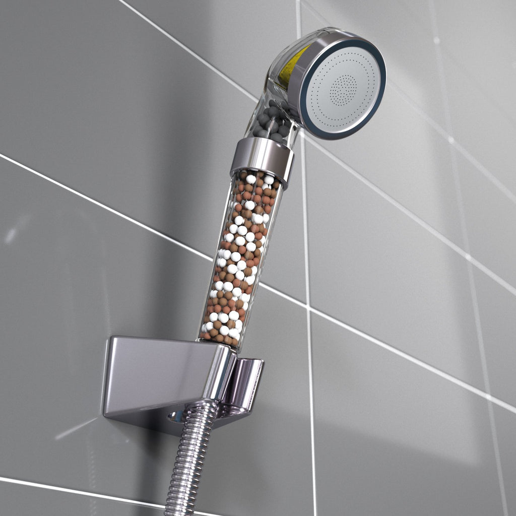 Chrome shower head with filter on a tiled bathroom wall