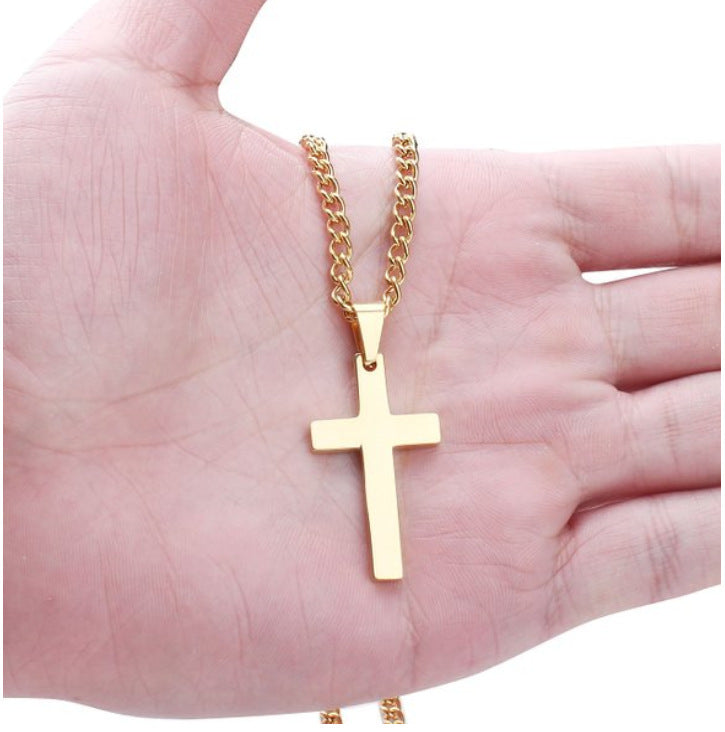 Gold cross necklace on a hand