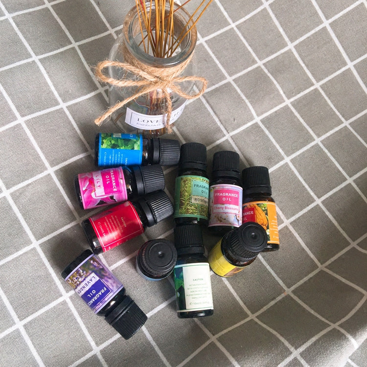 Collection of small bottles with colorful labels on a textured surface