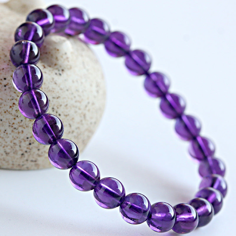 Purple beaded bracelet on a white background