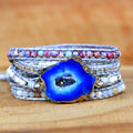 Multistrand bracelet with a blue agate stone on a wooden surface