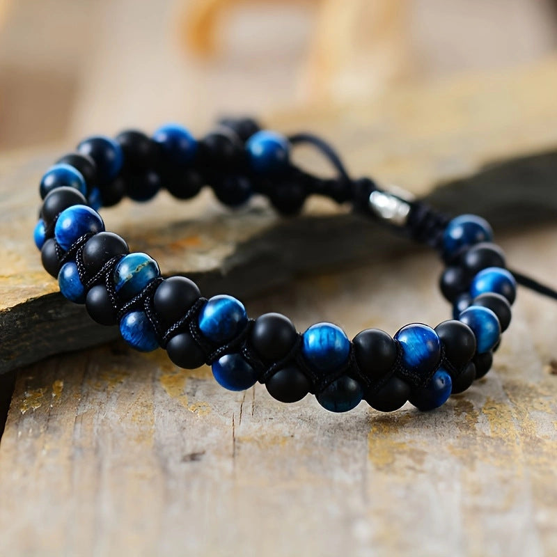 Black and blue beaded bracelet on a wooden surface