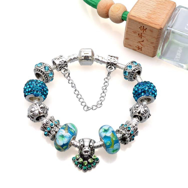 Bracelet with blue and silver beads on a white background