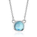 Silver necklace with a blue gemstone on a white background