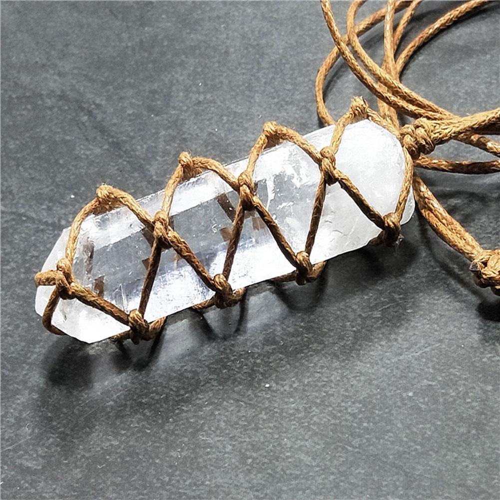 Crystal necklace with woven brown cord on a dark surface