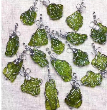 Green crystal pendants on a textured white background