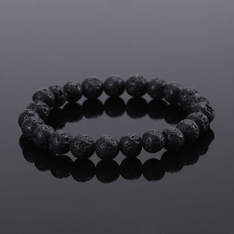 Black beaded bracelet on a reflective black surface