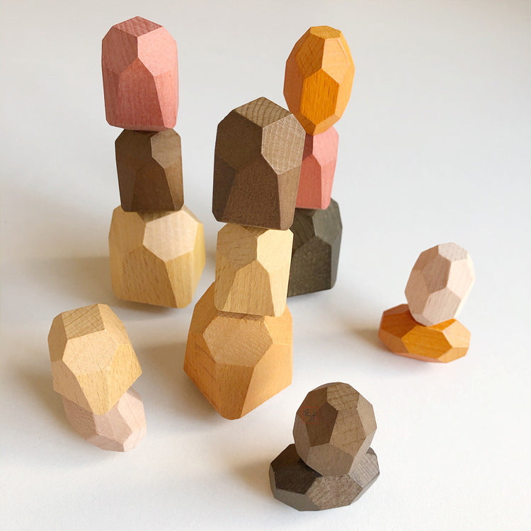 Set of wooden geometric blocks in various colors on a light background