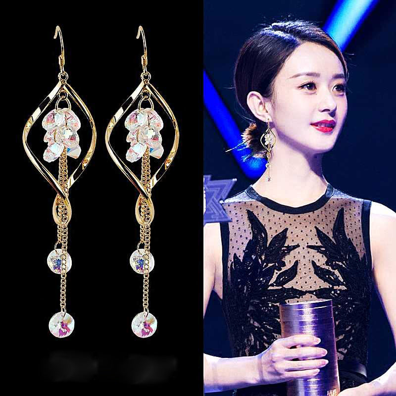 Earrings with floral design on a black background, next to a person wearing similar earrings.