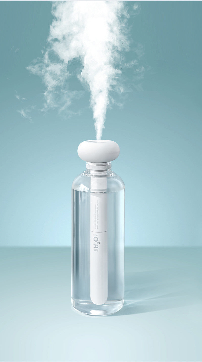 White handheld device emitting steam on a light blue background