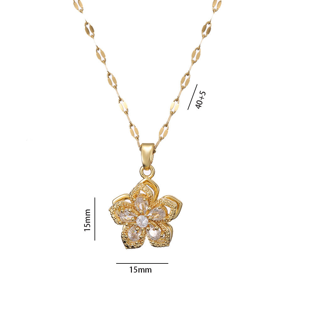 Gold necklace with a floral pendant on a white background
