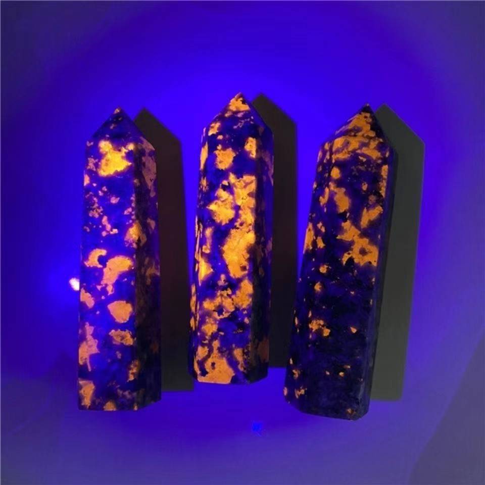 Three glowing crystal sticks under a blue light