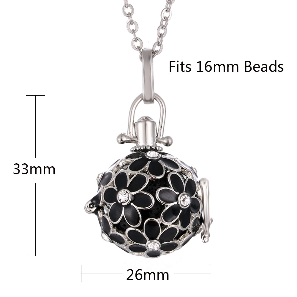 Jewelry clasp with black floral design and measurements on a white background