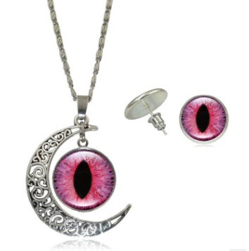Jewelry set with crescent moon and eye design necklace and earrings on a white background