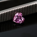 Heart-shaped pink diamond on a dark background