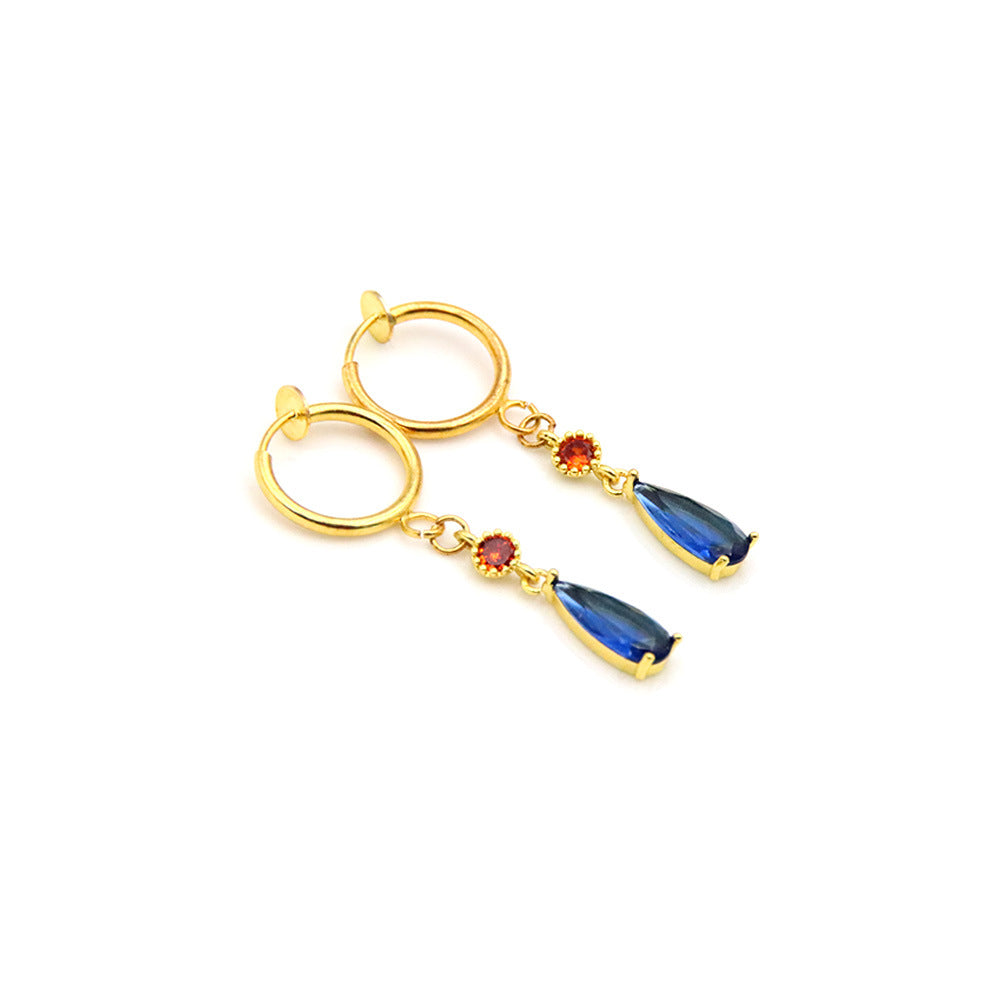Gold hoop earrings with blue and red teardrop-shaped gemstones on a white background
