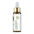 Bottle of chamomile essential oil with a white background