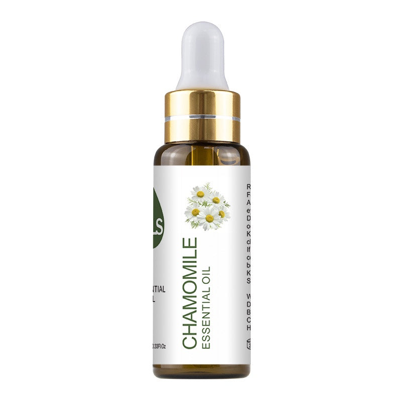 Bottle of chamomile essential oil with a white background