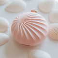 Pink textured object on a light pink background
