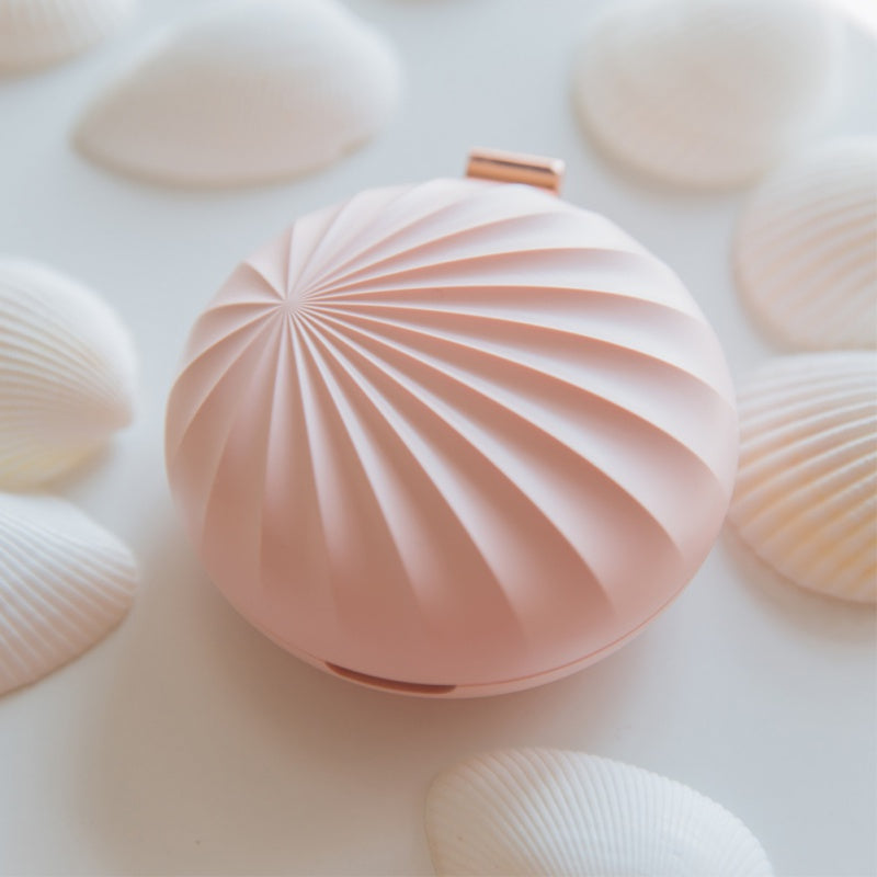 Pink textured object on a light pink background