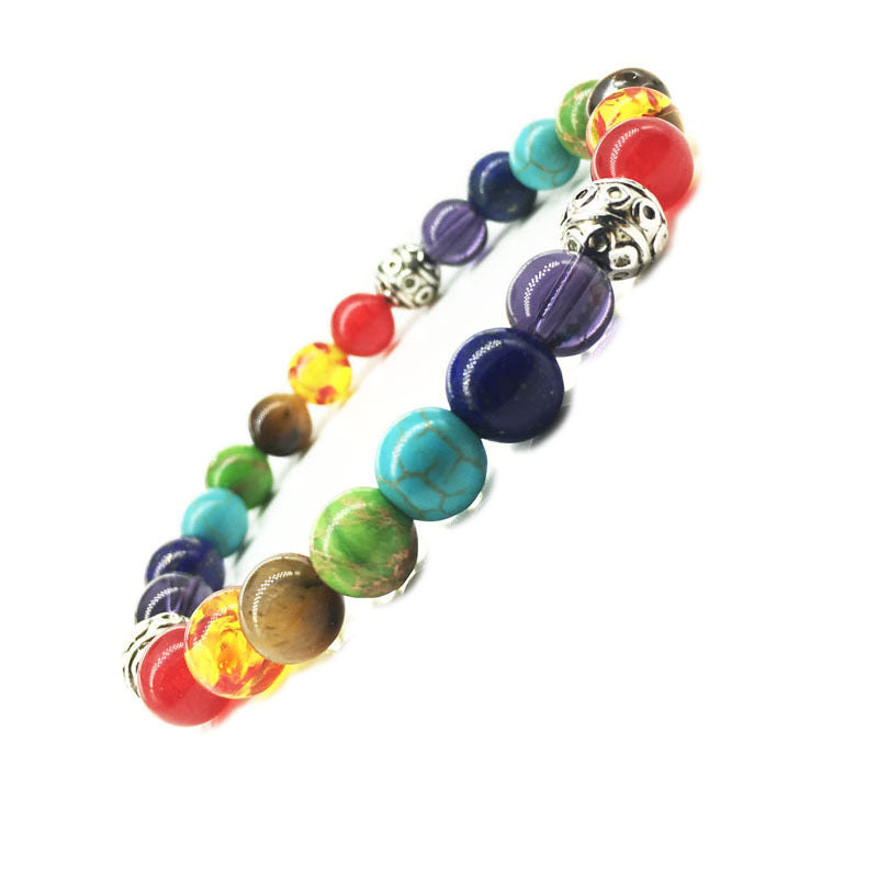 Multicolored beaded bracelet with a silver clasp on a white background