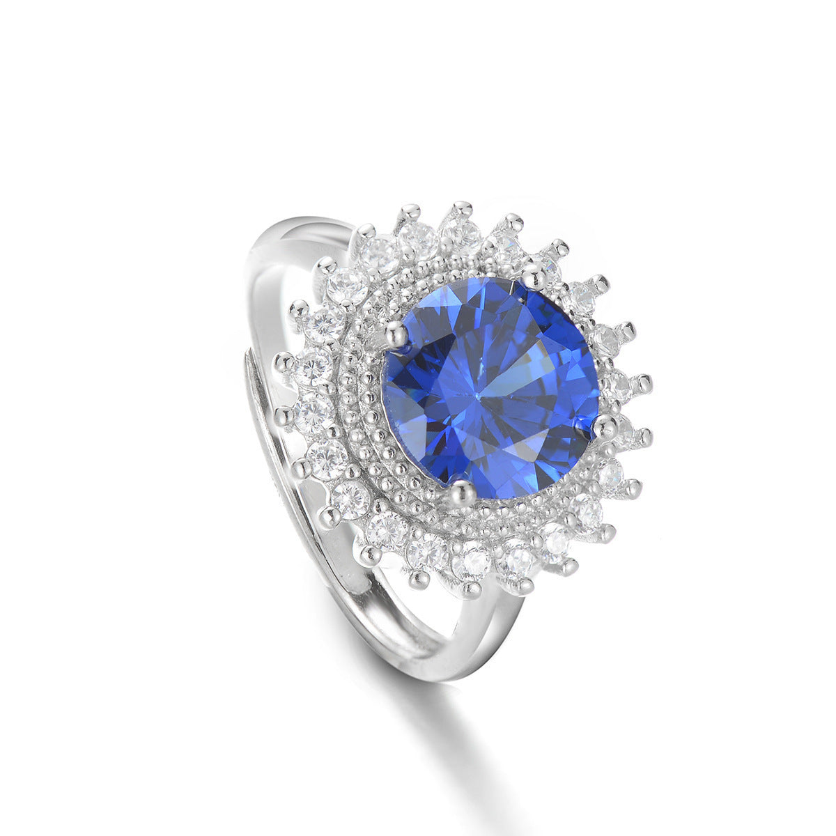 Silver ring with a blue gemstone on a white background