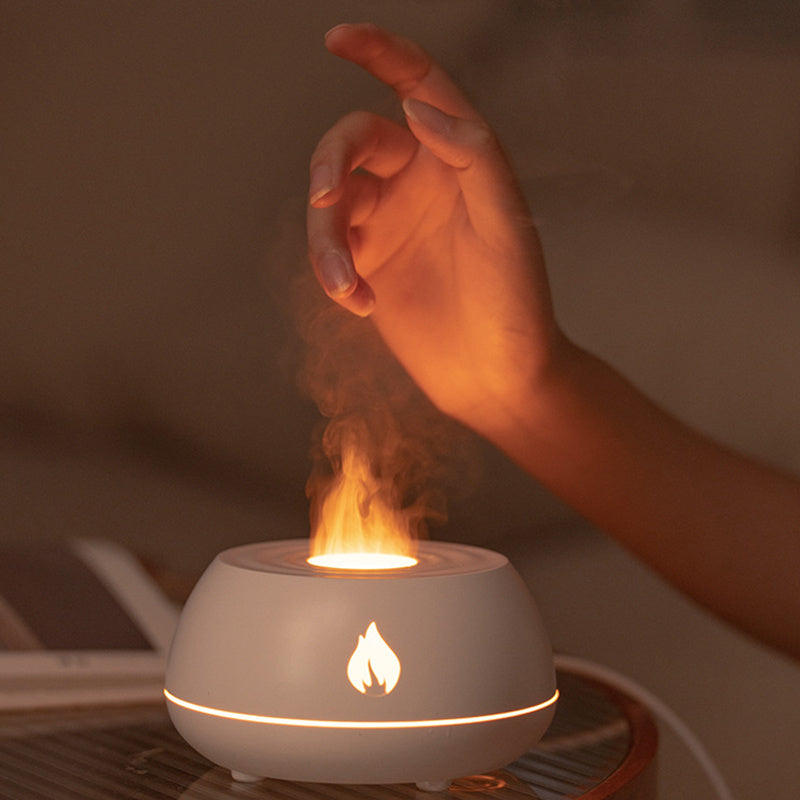 Hand interacting with a small flame in a white container on a blurred background