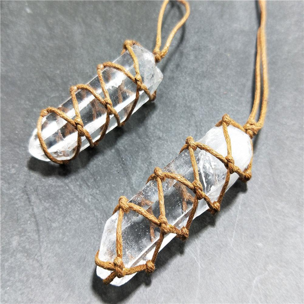 Two crystal necklaces with clear stones and brown cord on a gray background