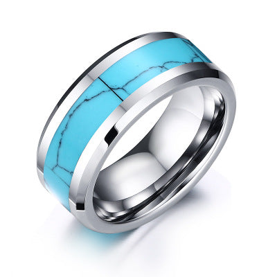 Ring with turquoise inlay and silver band on a white background