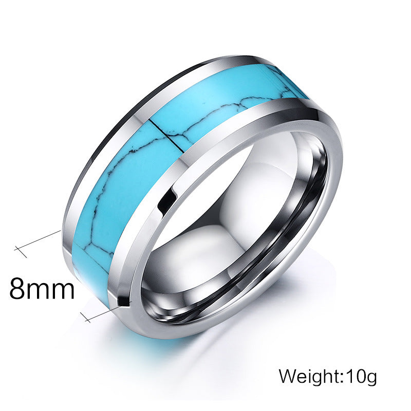 Ring with turquoise inlay and silver band on a white background