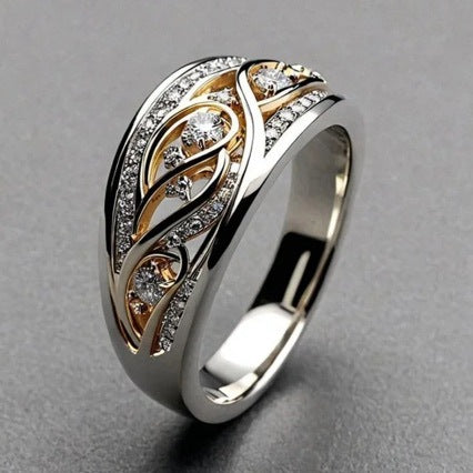 Gold and silver ring with diamond accents on a gray background