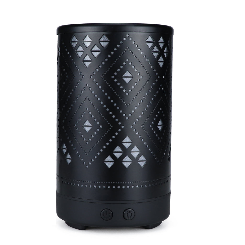 Black cylindrical lantern with geometric pattern on a white background