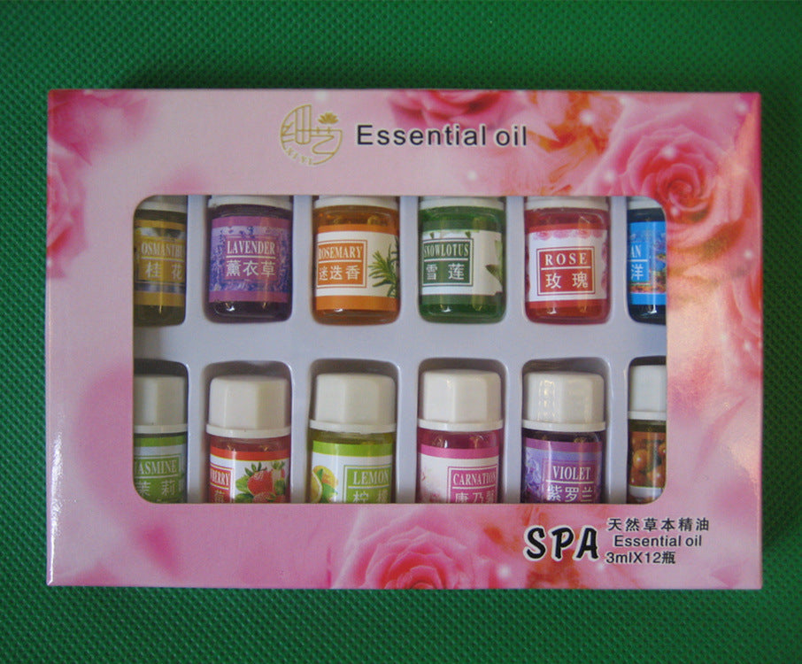 Box of essential oils with various scents on a green background