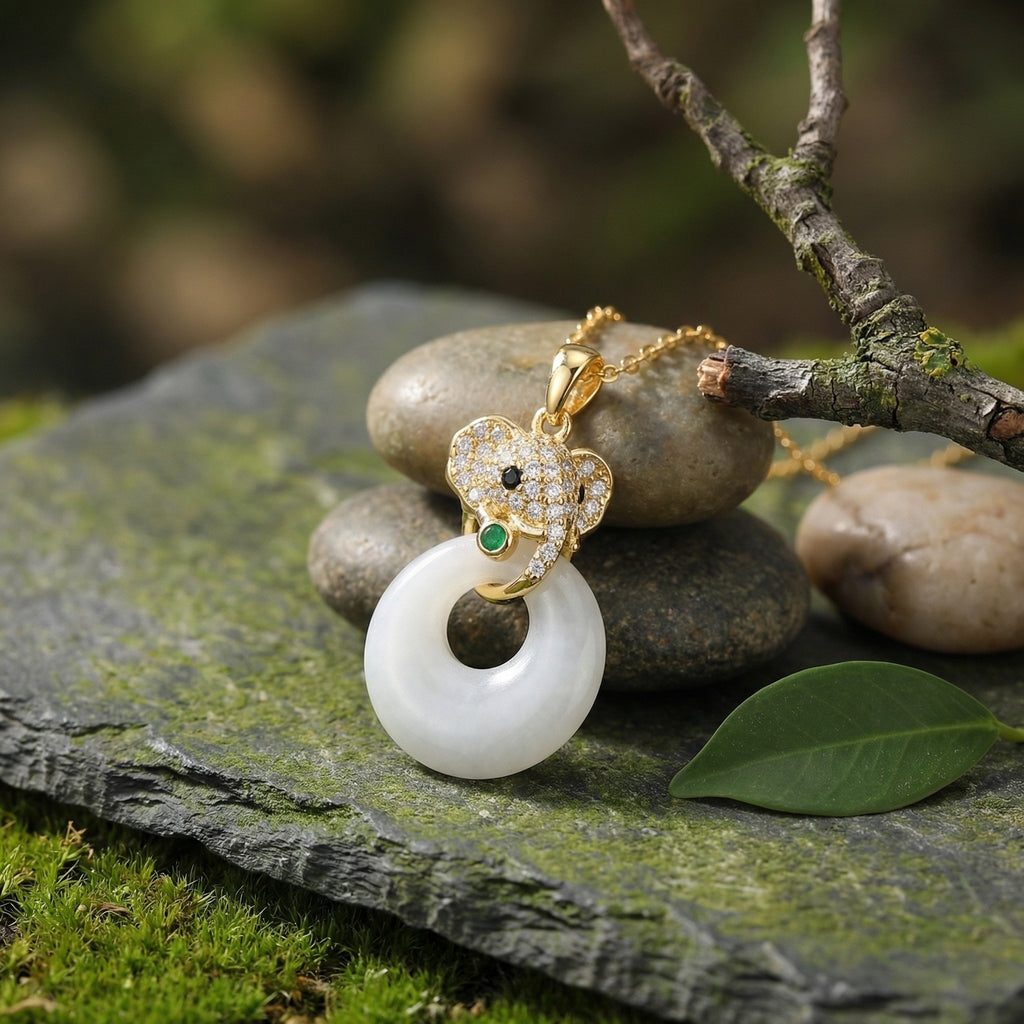Gold and white pendant necklace on stones with a natural background