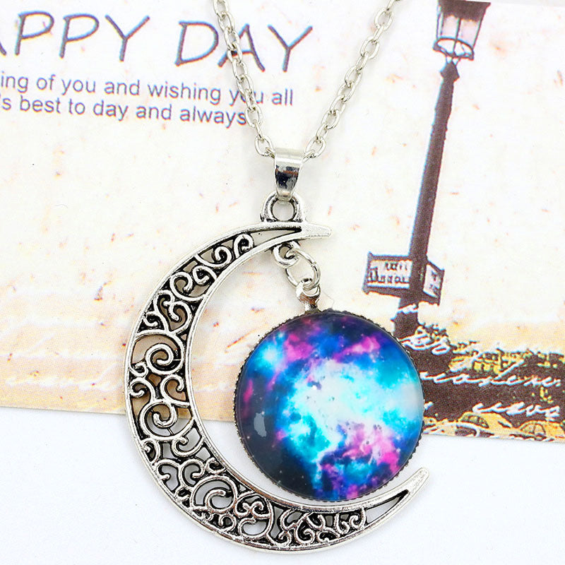 Necklace with a colorful pendant shaped like a galaxy on a decorative card.