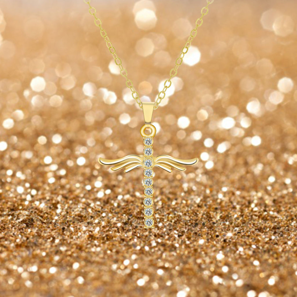Gold cross necklace with small diamonds on a glittery gold background
