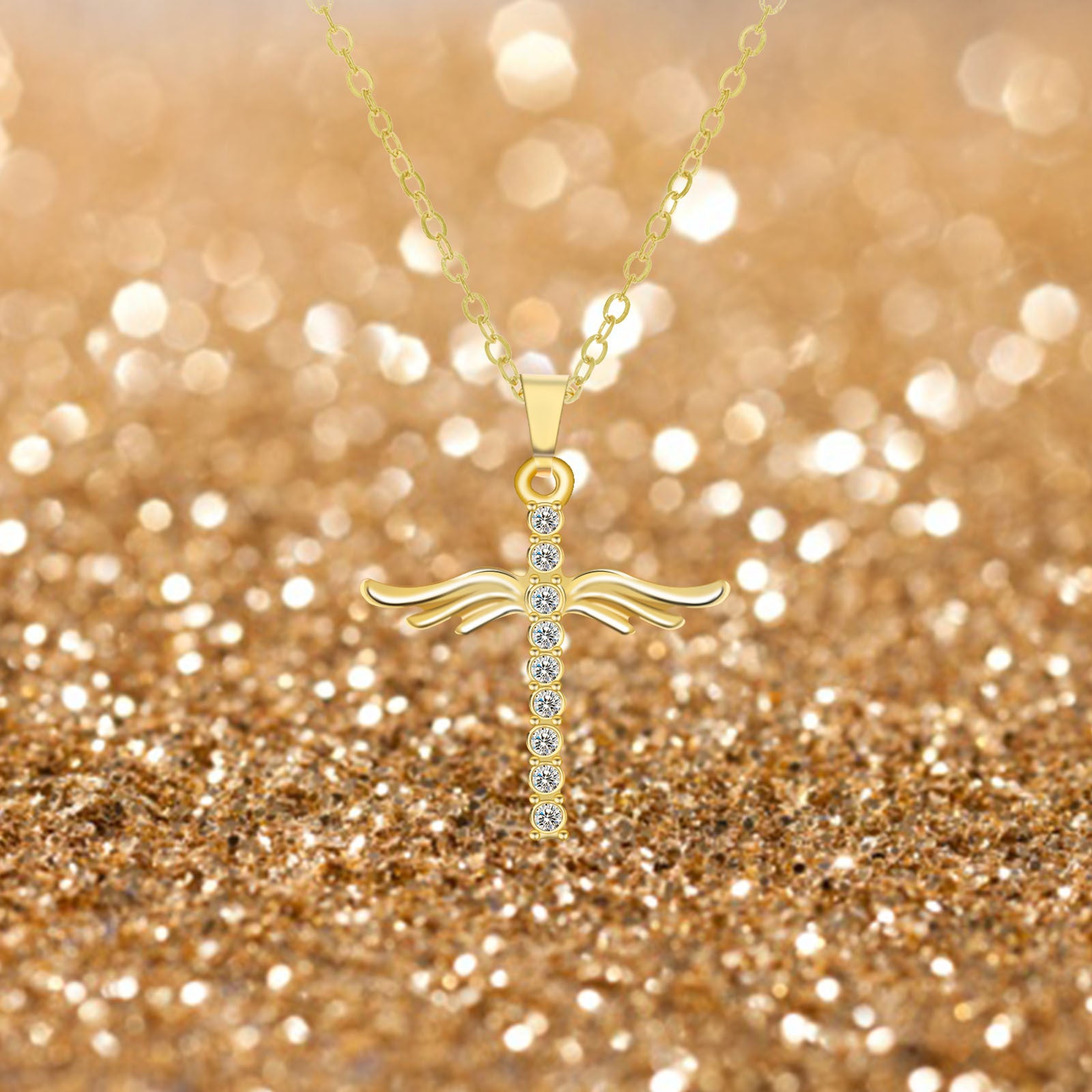 Gold cross necklace with small diamonds on a glittery gold background