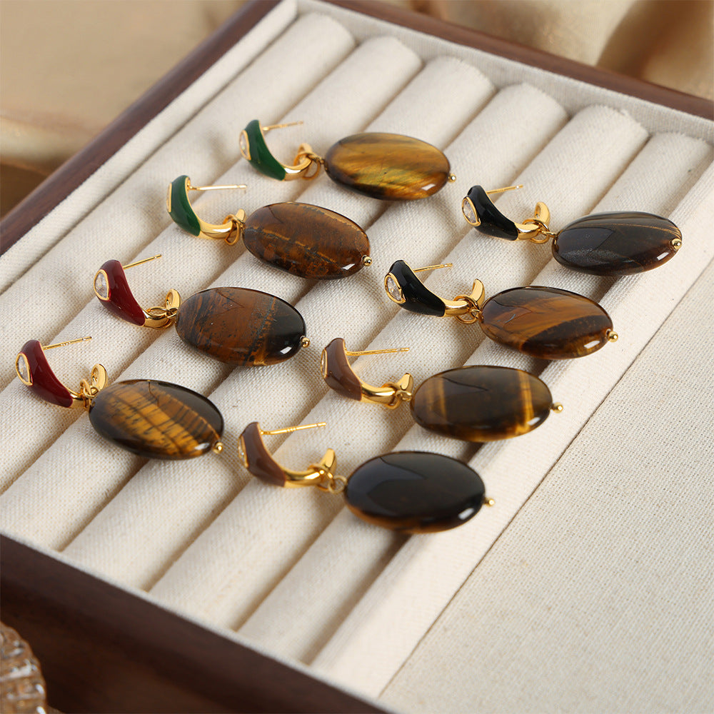Collection of earrings with gemstones on a jewelry display box.