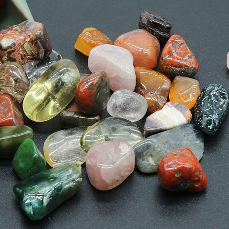 Assorted colorful gemstones on a dark surface