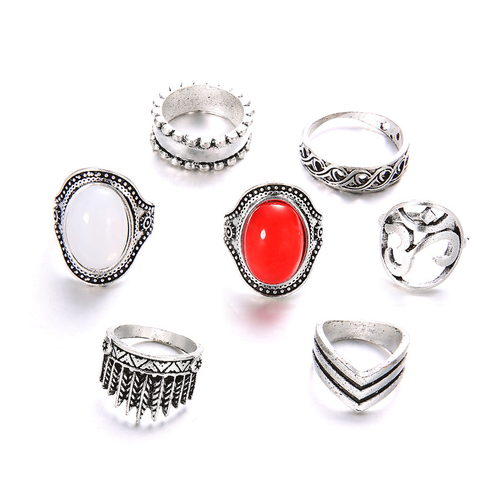 Set of silver rings with various designs on a white background