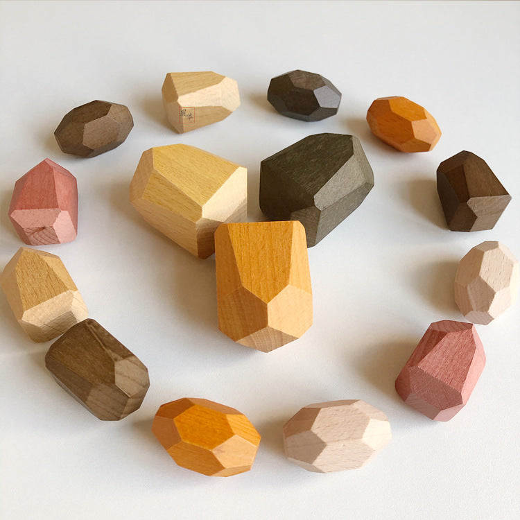 Set of wooden geometric shapes in various colors on a white background